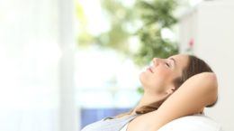 Woman On A Couch At Home Breathing Clean Air Shutterstock 324606446