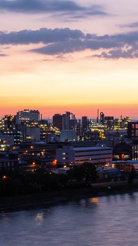 Urban area beside the river during sunset 