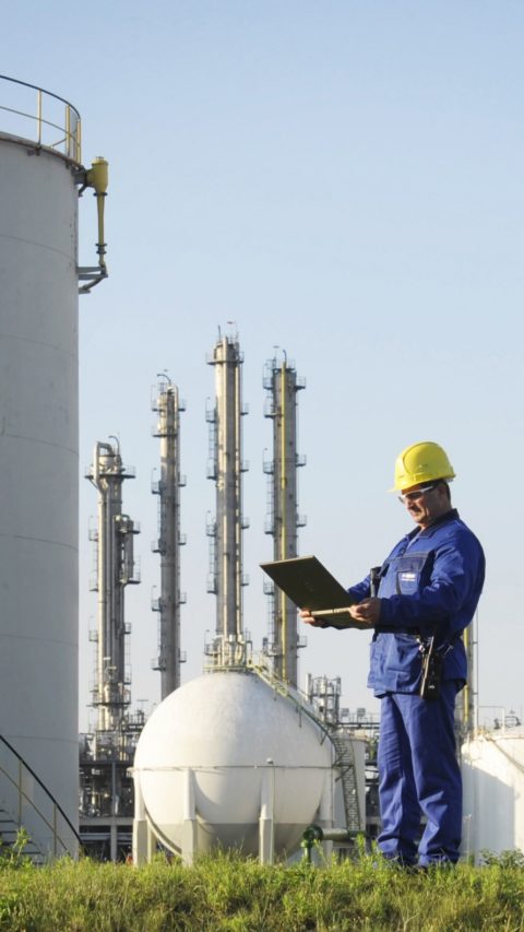 BASF employee standing on green grass outside production site 